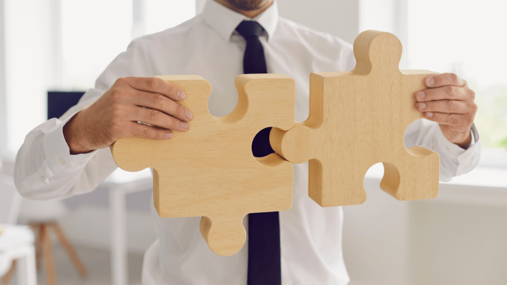 An employee holding pieces of puzzle together