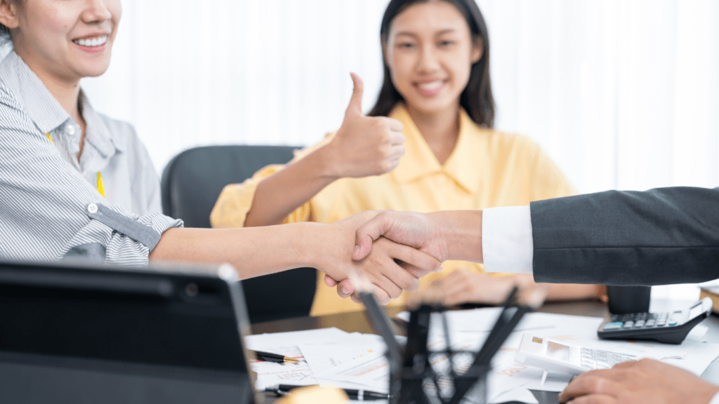 Two people handshaking due to a successful merge