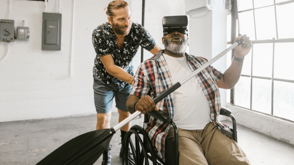 A man assisting an elderly in using virtual technology